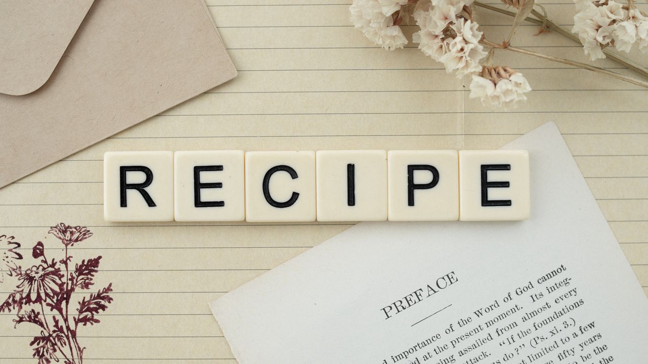 Crafting Captivating Headlines: Your awesome post title goes here Elegant flat lay featuring recipe letter tiles, dried flowers, and notes on lined paper.