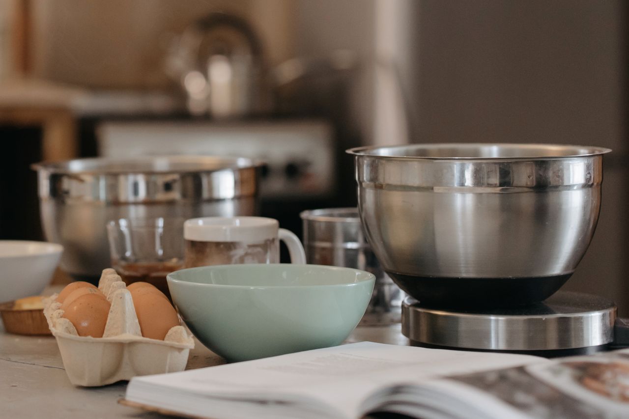 The Art of Drawing Readers In: Your attractive post title goes here A cozy kitchen setup with baking bowls, eggs, and kitchen utensils for a comforting cooking experience.